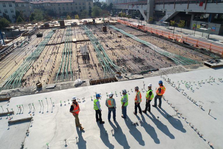 Construction professionals gathered at a project site