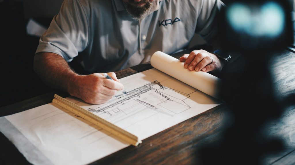 Architect working on project drawings at a desk